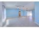 Spacious living room with tile floors, ceiling fan, and natural light, perfect for relaxing and entertaining at 429 Dorchester St, Port Charlotte, FL 33954