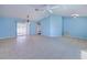 Bright living room featuring tile flooring, a ceiling fan, and sliding glass doors leading to the outdoors at 429 Dorchester St, Port Charlotte, FL 33954