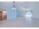 Open-concept living room with tile floors, an arched doorway, and ample space for furniture arrangement at 429 Dorchester St, Port Charlotte, FL 33954