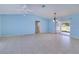 Spacious living room with tile flooring, ceiling fan, and sliding doors, providing plenty of natural light at 429 Dorchester St, Port Charlotte, FL 33954
