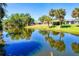 Picturesque waterfront with a view of palm trees and houses reflected in the water at 429 Dorchester St, Port Charlotte, FL 33954