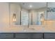 Close-up of bathroom vanity with quartz countertop and modern light fixtures at 4320 Vasco St, Punta Gorda, FL 33950