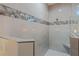 Close-up of walk-in shower with rain showerhead and decorative tile accents at 4320 Vasco St, Punta Gorda, FL 33950