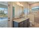 Bathroom featuring granite countertop, vanity with storage, and tiled shower at 4320 Vasco St, Punta Gorda, FL 33950