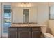 Bathroom featuring granite countertop, vanity with storage, mirror, and commode at 4320 Vasco St, Punta Gorda, FL 33950