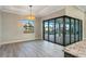 Dining room with stylish light fixture with sliding glass doors overlooking the pool at 4320 Vasco St, Punta Gorda, FL 33950