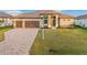 Charming home features a paver driveway, two-car garage, and well-manicured lawn at 4320 Vasco St, Punta Gorda, FL 33950