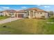 Home features a lush front lawn, two-car garage, and well-maintained landscaping at 4320 Vasco St, Punta Gorda, FL 33950