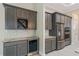 Kitchen features gray cabinets, granite countertops, a stainless steel fridge, and a built-in wine rack at 4320 Vasco St, Punta Gorda, FL 33950