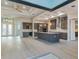 Spacious open-plan kitchen with gray cabinets, stainless steel appliances, granite countertops, and light wood flooring at 4320 Vasco St, Punta Gorda, FL 33950