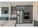 Modern kitchen with gray cabinets, stainless steel appliances, granite countertops, and a built-in microwave at 4320 Vasco St, Punta Gorda, FL 33950
