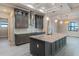 A modern kitchen boasts gray cabinets, stainless steel appliances, granite countertops, and a center island with a sink at 4320 Vasco St, Punta Gorda, FL 33950