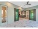 View from lanai showcasing tile flooring, ceiling fan and sliding glass doors to the kitchen at 4320 Vasco St, Punta Gorda, FL 33950