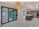 Open living area with sliding glass doors, a large kitchen island, and stylish lighting fixtures at 4320 Vasco St, Punta Gorda, FL 33950