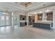 Open living area with a kitchen, bar, and dining area, featuring coffered ceilings and tile flooring at 4320 Vasco St, Punta Gorda, FL 33950