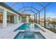 Stunning screened-in pool area overlooking a serene waterfront view, with kitchen access at 4320 Vasco St, Punta Gorda, FL 33950