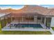 Backyard features a screened in pool with integrated jacuzzi and stone tile deck at 4320 Vasco St, Punta Gorda, FL 33950