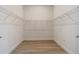 Walk-in closet featuring wrap-around wire shelving and wood-look tile flooring at 4320 Vasco St, Punta Gorda, FL 33950