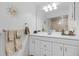 Bright bathroom features a large mirror, white cabinets, and vanity space at 5783 Sabal Trace Dr # 103B57, North Port, FL 34287