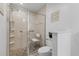 Bathroom showcasing a glass enclosed shower with seating and tiled walls at 5783 Sabal Trace Dr # 103B57, North Port, FL 34287