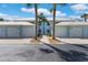 Charming light-blue two-story home with white trim, dual garages, and mature palm trees at 5783 Sabal Trace Dr # 103B57, North Port, FL 34287