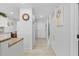 Inviting hallway featuring tile floors, white walls, and seamless transition to other spaces at 5783 Sabal Trace Dr # 103B57, North Port, FL 34287