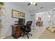 Functional home office space with a desk, ergonomic chair, and view of the dining area through glass doors at 5783 Sabal Trace Dr # 103B57, North Port, FL 34287