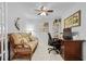 Inviting home office with a comfortable sofa, desk, and decorative shelves at 5783 Sabal Trace Dr # 103B57, North Port, FL 34287