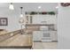 Functional kitchen featuring white cabinets, stone counter tops, tile floors and modern appliances at 5783 Sabal Trace Dr # 103B57, North Port, FL 34287