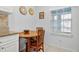 Cozy kitchen nook features a round wood table and decorative wall art near the window at 5783 Sabal Trace Dr # 103B57, North Port, FL 34287