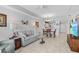 Spacious living room with a comfortable sofa, coffee table, and partial view of the kitchen and dining area at 5783 Sabal Trace Dr # 103B57, North Port, FL 34287