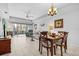 Open living and dining area featuring a comfortable sofa and sliding glass doors to the lanai at 5783 Sabal Trace Dr # 103B57, North Port, FL 34287