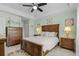 Relaxing main bedroom with a spacious layout, wooden furniture, and a ceiling fan at 5783 Sabal Trace Dr # 103B57, North Port, FL 34287