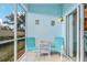 Cozy screened patio with light blue walls, seating, and views of green landscape at 5783 Sabal Trace Dr # 103B57, North Port, FL 34287