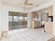 Dining area with ceiling fan and glass sliding doors to a sunroom adjacent to kitchen at 6991 Pompey St, North Port, FL 34287