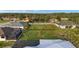 A large green lot sits next to a home and screened lanai under a durable metal roof at 7363 N Moss Rose, Punta Gorda, FL 33955