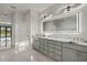 Modern bathroom with dual sinks, quartz countertops, gray cabinets and a decorative mirror with integrated lighting at 7363 N Moss Rose, Punta Gorda, FL 33955
