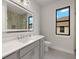 Modern bathroom with gray cabinets, a large mirror, beautiful countertops and a glass enclosed shower at 7363 N Moss Rose, Punta Gorda, FL 33955