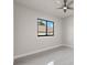 Bright bedroom featuring a ceiling fan, a window providing natural light, and sleek tile flooring at 7363 N Moss Rose, Punta Gorda, FL 33955