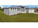Stylish home with a metal roof, manicured lawn, and a two-car garage at 7363 N Moss Rose, Punta Gorda, FL 33955