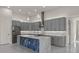 Bright and airy kitchen with stainless steel appliances, gray cabinetry, and a stone kitchen island at 7363 N Moss Rose, Punta Gorda, FL 33955