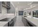 Spacious kitchen featuring gray cabinetry, quartz countertops, and stainless steel appliances in an open concept floor plan at 7363 N Moss Rose, Punta Gorda, FL 33955