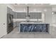 Modern kitchen featuring stainless steel appliances, gray cabinets, and a unique stone kitchen island at 7363 N Moss Rose, Punta Gorda, FL 33955