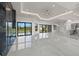 Open-concept living space with ceiling fan, a black marble fireplace wall, and views of the backyard at 7363 N Moss Rose, Punta Gorda, FL 33955