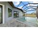 Screened-in pool area with brick pavers surrounding pool with blue skies above at 7363 N Moss Rose, Punta Gorda, FL 33955