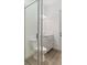 Bathroom featuring toilet, vanity with storage, and glass-enclosed shower at 8604 Shore Lake Dr, Englewood, FL 34224