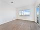Bedroom with tile floors, large window with a scenic view, and sliding glass doors to the patio at 8604 Shore Lake Dr, Englewood, FL 34224