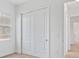 Bedroom featuring window with blinds and closet with sliding doors at 8604 Shore Lake Dr, Englewood, FL 34224