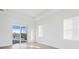 Bedroom showcasing a tray ceiling and a sliding door to the backyard at 8604 Shore Lake Dr, Englewood, FL 34224