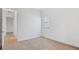 Bright bedroom featuring wood-look tile flooring, white walls, and a window with blinds at 8604 Shore Lake Dr, Englewood, FL 34224